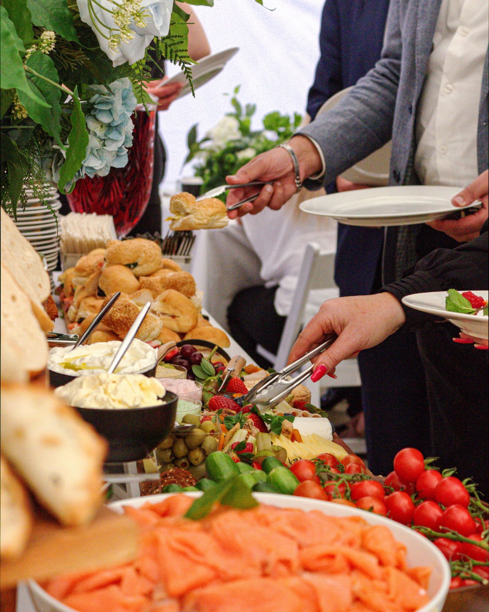 Guests serving themselves at a grazing table hosted by GD Events Group