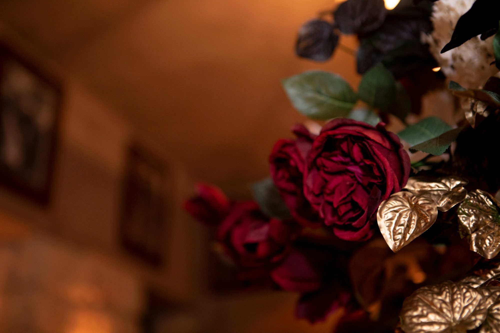 Deep red roses and gilded foliage in a GD Events Group arrangement, Sydney